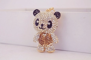 Close-up of cute panda keychain with sparkling rhinestones and a golden metal ring