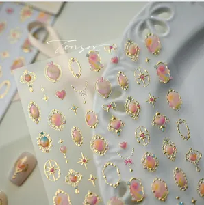 Macro shot of 3D embossed nail stickers featuring vintage gemstone patterns and gold frames