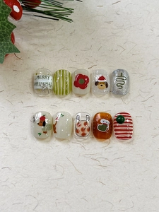 Close-up of festive Christmas nail stickers featuring Santa dog, socks, and floral designs