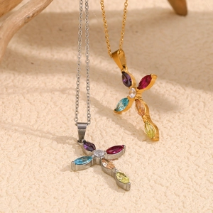 Close-up of gold and silver cross necklaces with vibrant multi-colored inlaid gemstones