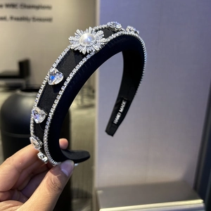 Handmade black sponge headband with sparkling rhinestones and a large pearl accent