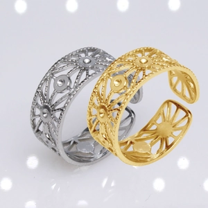 Close-up of gold and silver adjustable rings with geometric hollow-out patterns