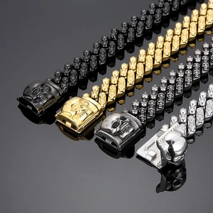 Macro detail of gothic skull Cuban link bracelets in black, gold, and silver finishes
