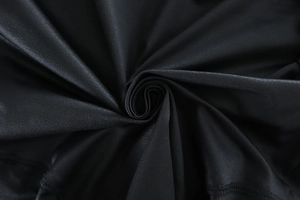 Close-up of premium black high-performance athletic fabric with silky smooth texture
