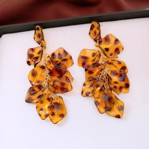 Detail of leopard print resin petals on gold tassels for vintage long drop earrings