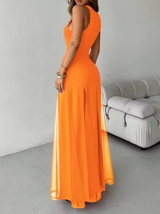 Detail of elegant orange sleeveless maxi dress with sheer mesh side slit and long hem
