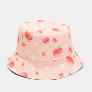 Close-up of pink reversible bucket hat with peach and floral prints for sun protection