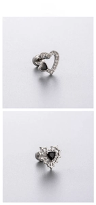 Macro detail of gothic heart earrings with black zircon and silver spider web design