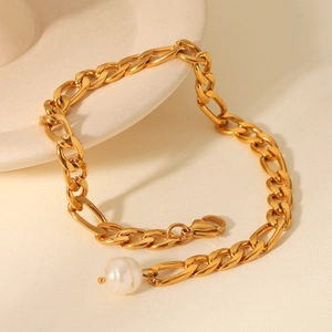 Detail of 18K gold plated stainless steel Figaro chain anklet with freshwater pearl charm