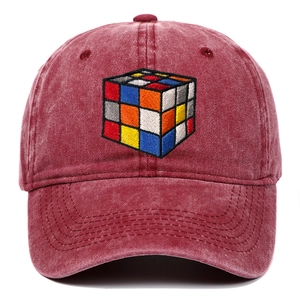 Detailed embroidery of a colorful Rubik's Cube on a washed burgundy cotton baseball cap