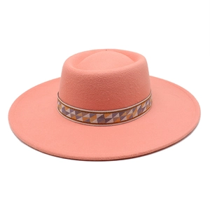 Close-up of coral wool felt hat with bohemian geometric pattern jacquard ribbon detail