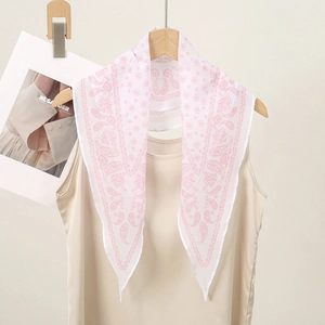 Detail of white scarf with pink paisley pattern hanging in a triangle shape