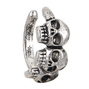 Detail of vintage silver gothic ring featuring three stacked skulls in punk style