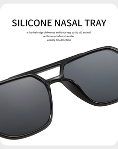 Close-up of anti-slip silicone nose pads on black double-bridge oversized sunglasses