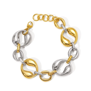 Detail of two-tone chain bracelet with star and moon charms and lobster clasp