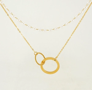 Detail view of double-layer necklace with white pearls and gold interlocking rings