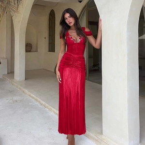 Detail of red velvet gown featuring 3D floral accents and handcrafted beadwork details