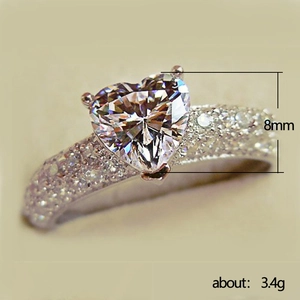 Sparkling heart-shaped zircon ring with 8mm center stone and pave-set band in silver