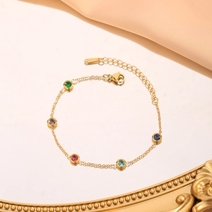 Elegant gold stainless steel slim bracelet with five colorful round gemstones on mirror