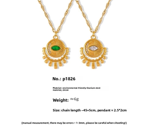 Detail of sun and moon eye pendants with green and white zircon on gold titanium necklaces