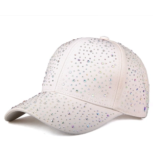 Detail view of colorful rhinestones on a cream cotton canvas baseball cap with curved brim