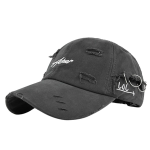 Detail of distressed dark grey baseball cap showing torn fabric and metal rings