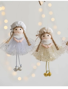 Detail of Christmas angel ornaments with sequined tulle skirts and golden metal bells