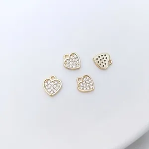 Macro detail of four 14K gold plated heart pendants with micro-pave cubic zirconia