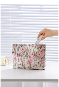 Detailed close-up of a floral tulip fabric cosmetic bag with a zipper and high capacity