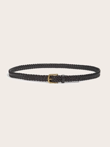 Close-up of black braided leather belt with vintage bronze buckle on beige background