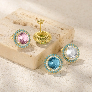 Macro detail of round gold stud earrings with colorful gemstones and turquoise beads