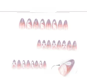 Detail of almond-shaped press-on nails with purple gradient, 3D white petals and pearls