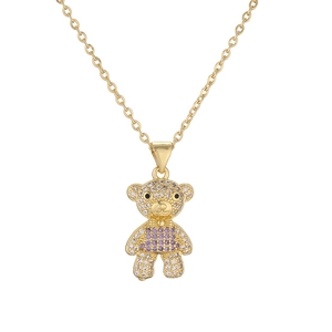 Detailed close-up of teddy bear pendant with purple and clear crystals on gold chain