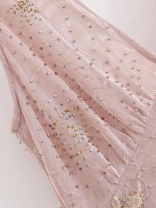 Detail of pink mesh fabric with gold and silver sequins and hand-beaded embroidery