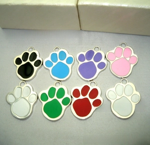 Colorful metal paw print pet tags with variety of enamel finishes and hanging rings