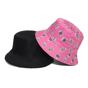 Detail view of cotton bucket hats in solid black and pink fast food cartoon print patterns