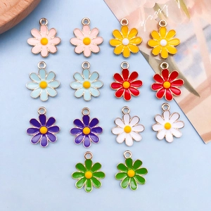 Macro shot of colorful daisy flower pendants in alloy with vibrant enamel and gold finish