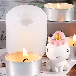 Detailed view of translucent silicone unicorn mold alongside a finished candle