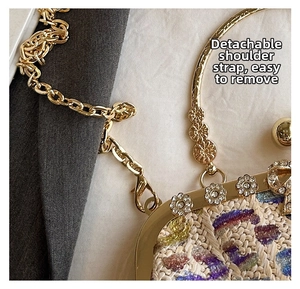 Detail of colorful woven evening bag with golden chain and crystal flower clasp
