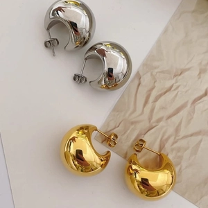 Polished silver and gold chunky hoop earrings with elegant teardrop design for women