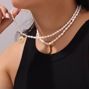 Double-layered baroque freshwater pearl necklace with gold shell pendant on model