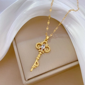 Luxurious vintage gold titanium key necklace with crystal pavé and large oval diamond