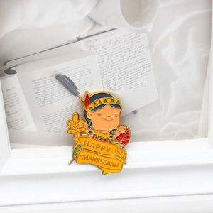 Detail of enamel pin featuring Indian cartoon character with Happy Thanksgiving banner