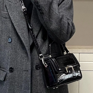 Fashionable black crocodile pattern square handbag with silver metal buckle on model