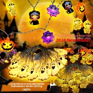 Macro shot of Halloween LED string lights with ghost, pumpkin, and spider web icons