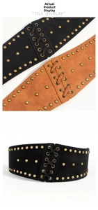 Detail of vintage corset belt with metallic rivets and lace-up design in black and brown