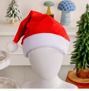 Close-up of red velvet Christmas hat with white plush trim and pompom on a model
