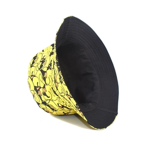 Fashionable yellow bucket hat with cartoon duck prints and black reversible lining