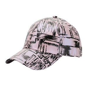 Close-up of pink PU leather baseball cap with black graffiti print and curved brim details