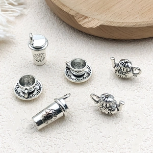 Detailed view of silver tea and coffee pendants with engraved Coffee and Tea Time text